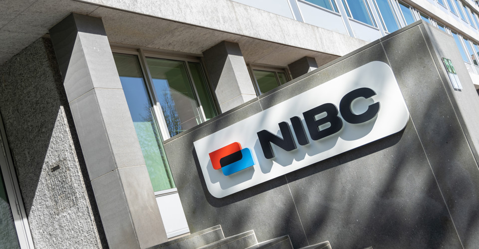 NIBC company logo on a facade, visible above the stairs leading to the entrance.